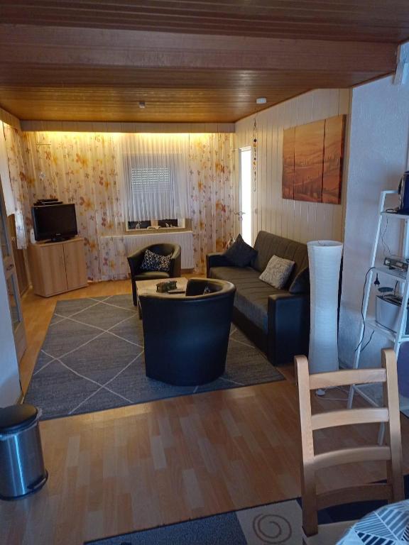 a living room with a couch and a table at Ferienwohnung Hilla in Taben-Rodt