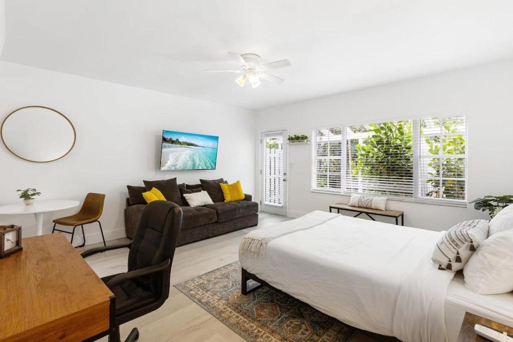 a bedroom with a bed and a living room at Lovely Studio in the Heart of Victoria Park in Fort Lauderdale