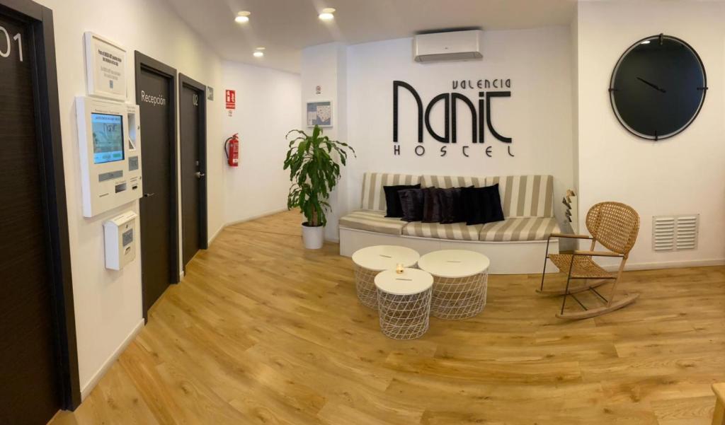 a living room with a couch and a table and chairs at Nanit Valencia Hostel in Valencia