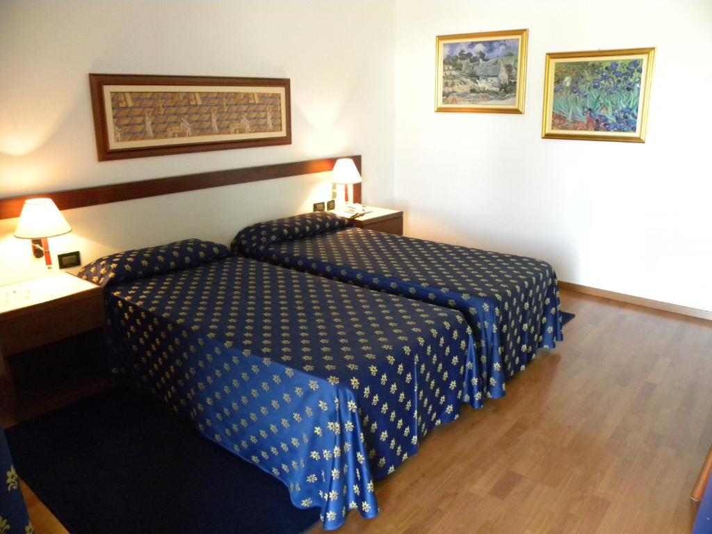 Postel nebo postele na pokoji v ubytování Arcotel