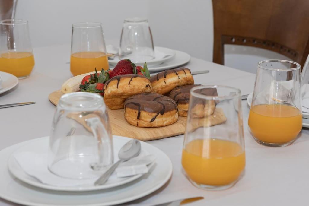 a table with a plate of pastries and orange juice at Alexas country house in Kamena Vourla