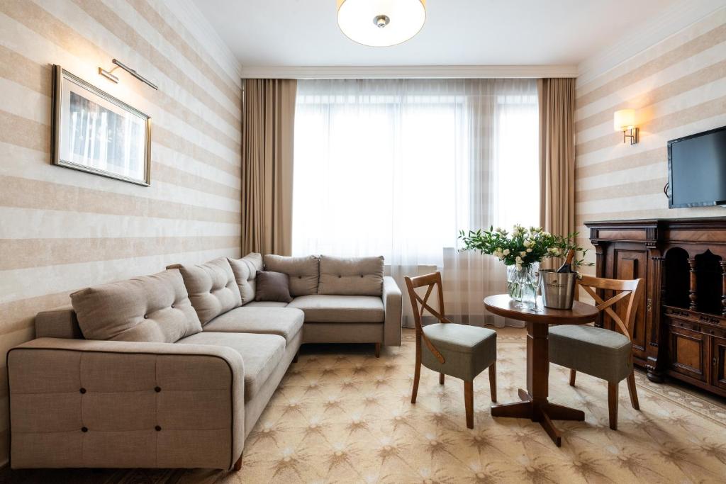 a living room with a couch and a table at Hotel Esperanto in Białystok