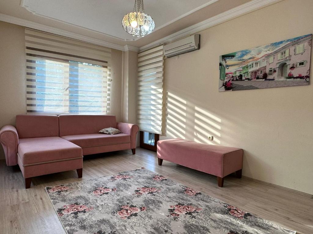 a living room with a couch and two chairs and a rug at ÖZTÜRK Apart in Trabzon