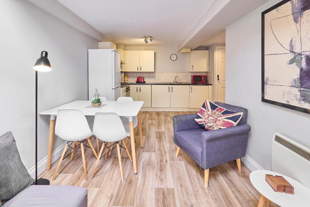 a kitchen and living room with a table and chairs at Host & Stay - Roper Road in Canterbury