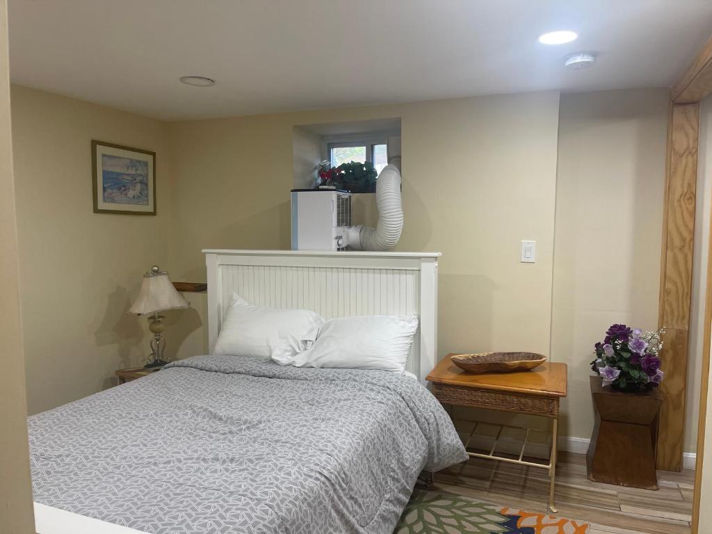 a bedroom with a bed and a table and a microwave at Welcome to Malden - Boston in Malden