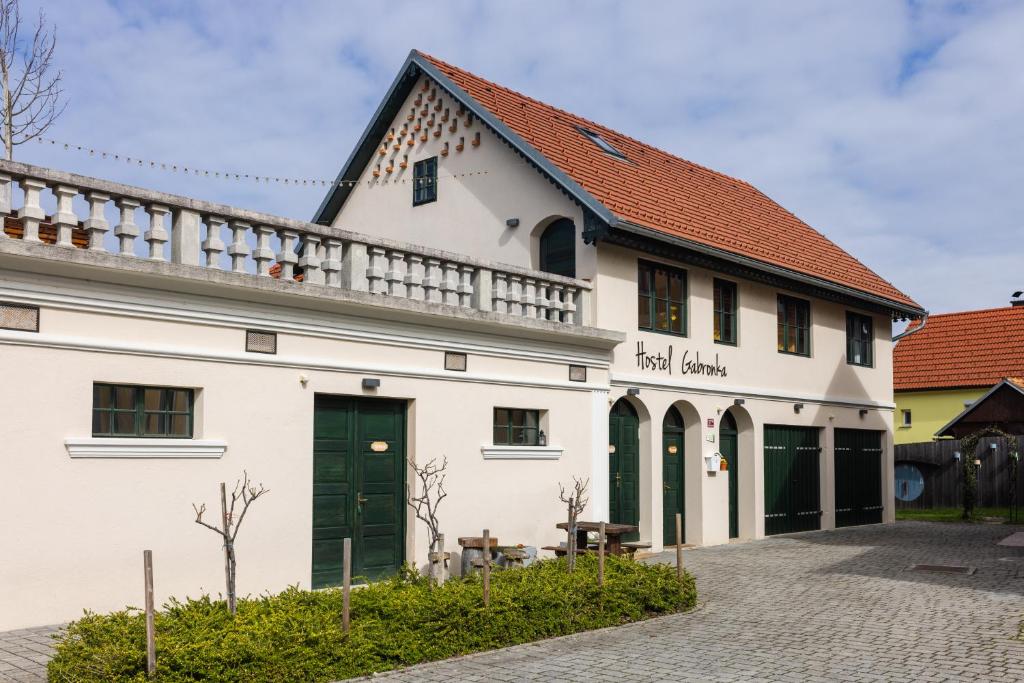 un edificio blanco con techo rojo en Hostel Gabronka en Bistrica ob Sotli