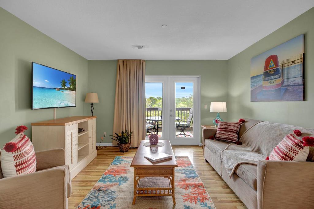 a living room with a couch and a tv at Coconut Mallory Resort and Marina in Key West