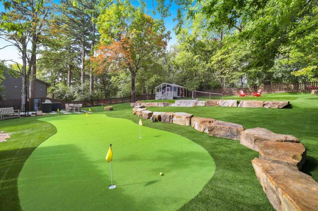 a golf course with a retaining wall and a putting green at Retro Razorback-Pickleball-Golf-Spa-UofA in Fayetteville