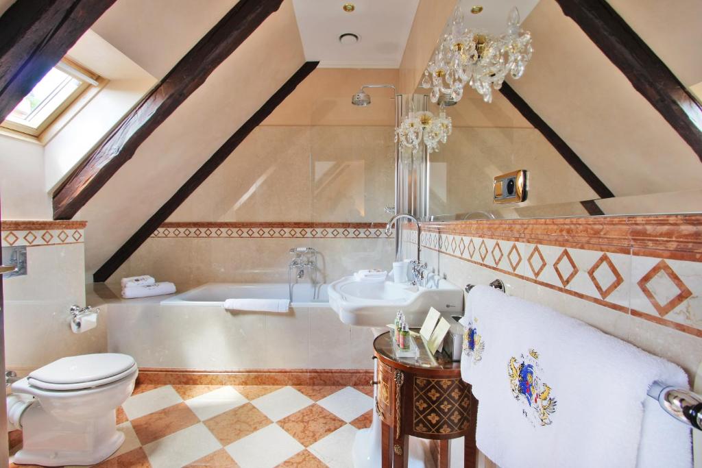 a bathroom with a tub and a toilet and a sink at Alchymist Grand Hotel and Spa - Preferred Hotels & Resorts in Prague