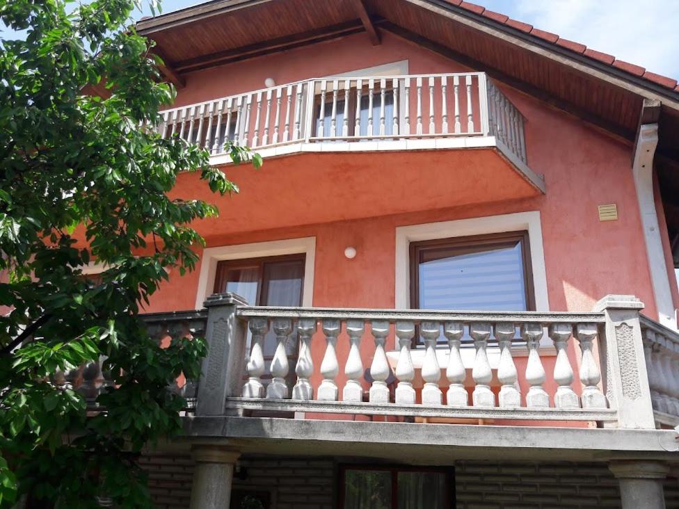 a balcony of a house with a white railing at Júlia Apartman in Balatonalmádi