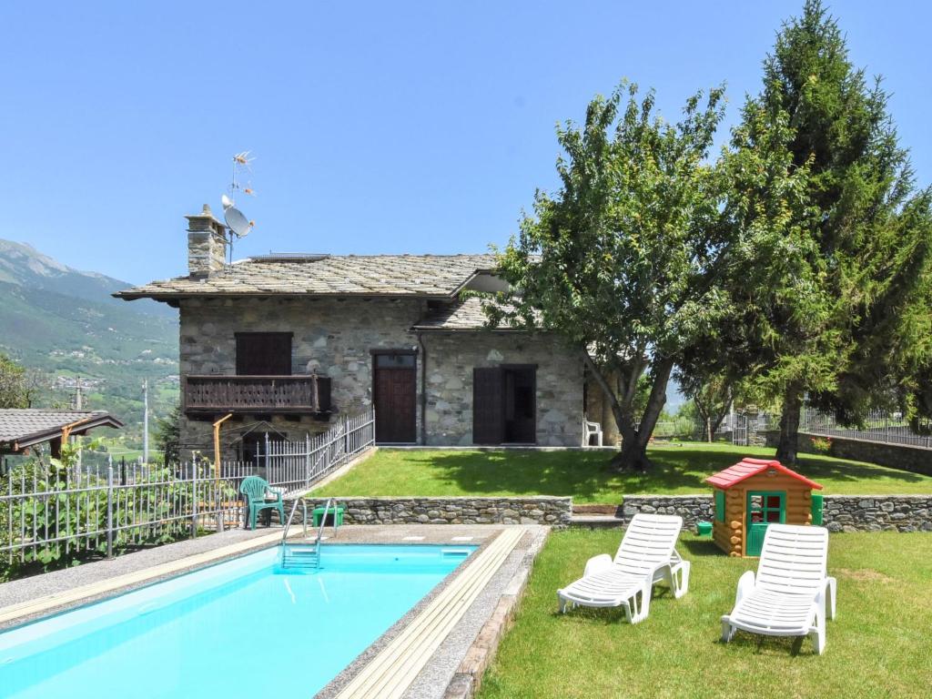 a villa with a swimming pool in front of a house at Apartment Maison Pro de Solari-2 by Interhome in Fenis