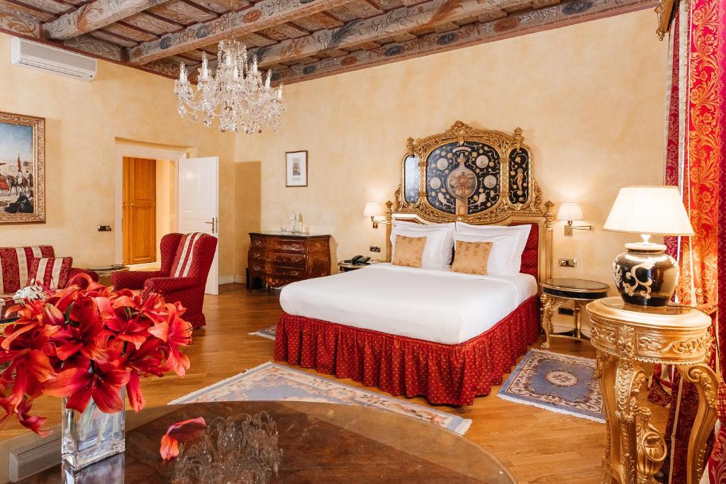 a bedroom with a bed and a chandelier at Alchymist Grand Hotel and Spa - Preferred Hotels & Resorts in Prague