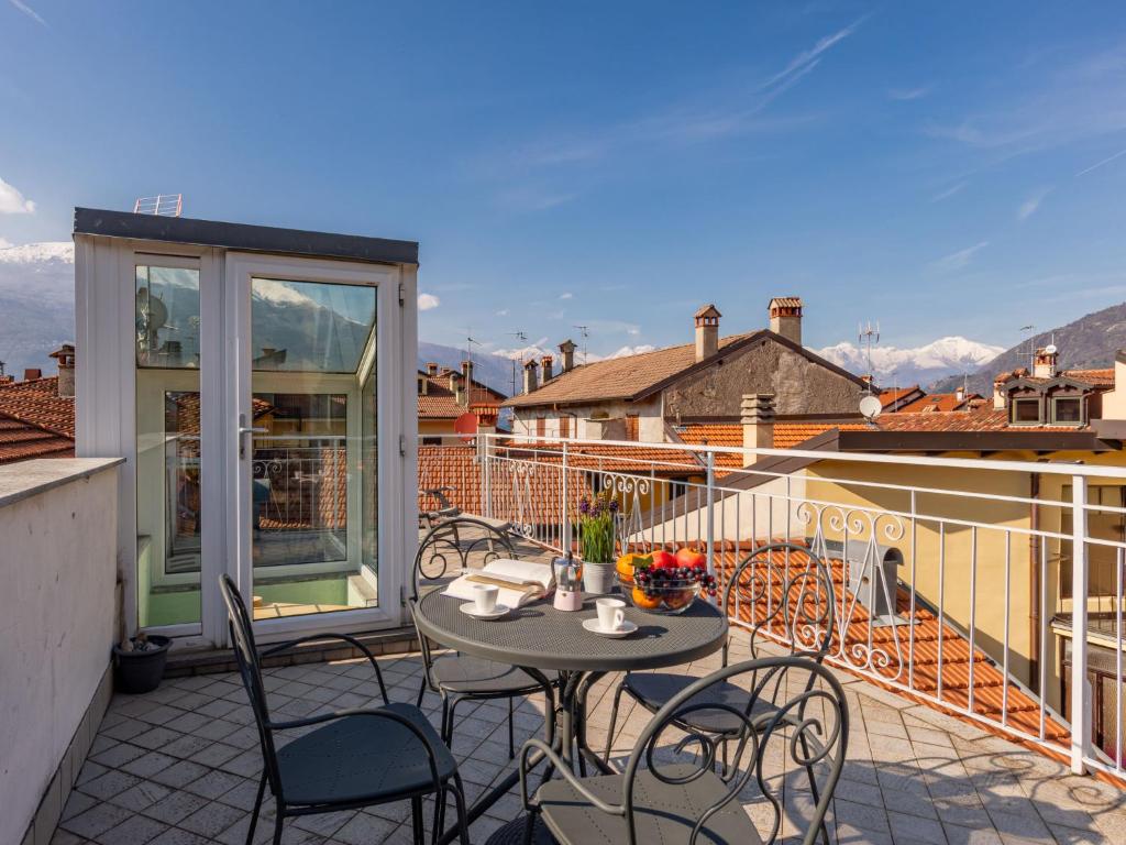 a patio with a table and chairs on a balcony at Apartment Blue Diamond by Interhome in Bellano