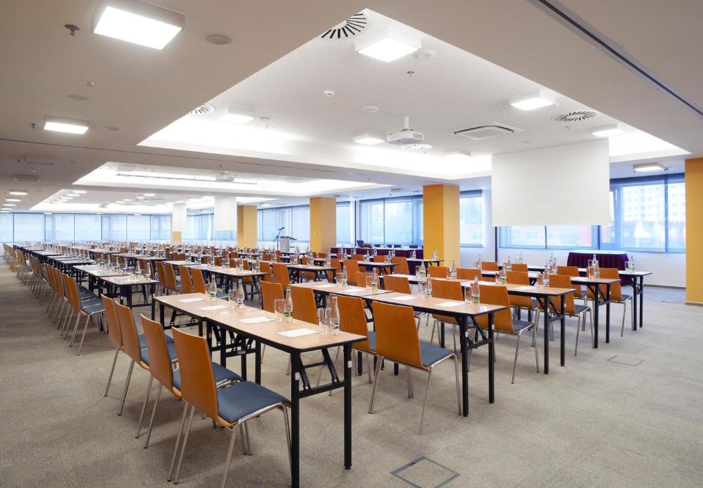 a large room with tables and chairs and a whiteboard at Clarion Congress Hotel České Budějovice in České Budějovice