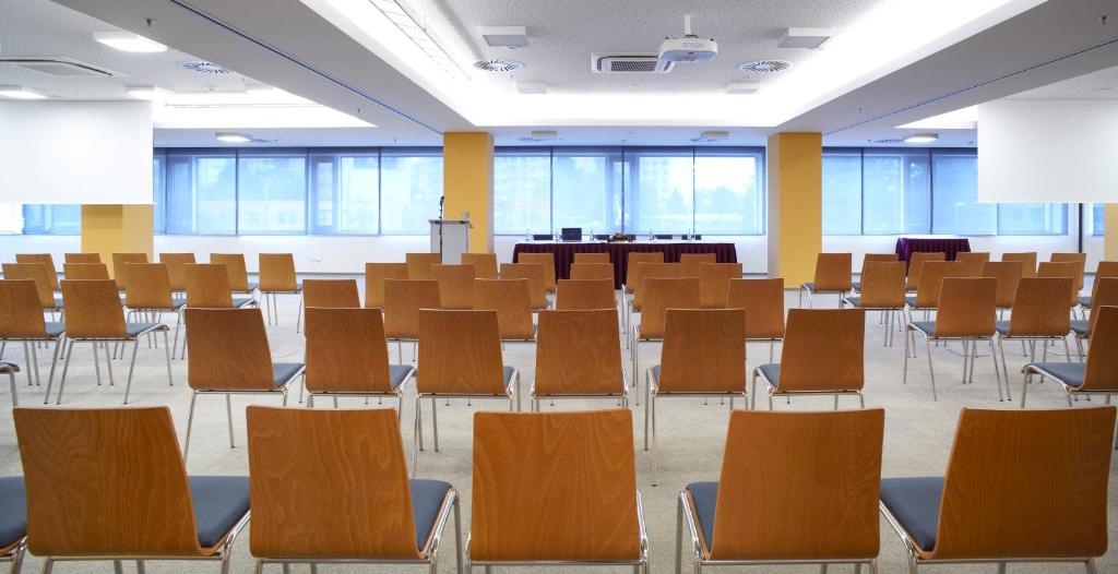 an empty lecture room with chairs and tables at Clarion Congress Hotel České Budějovice in České Budějovice