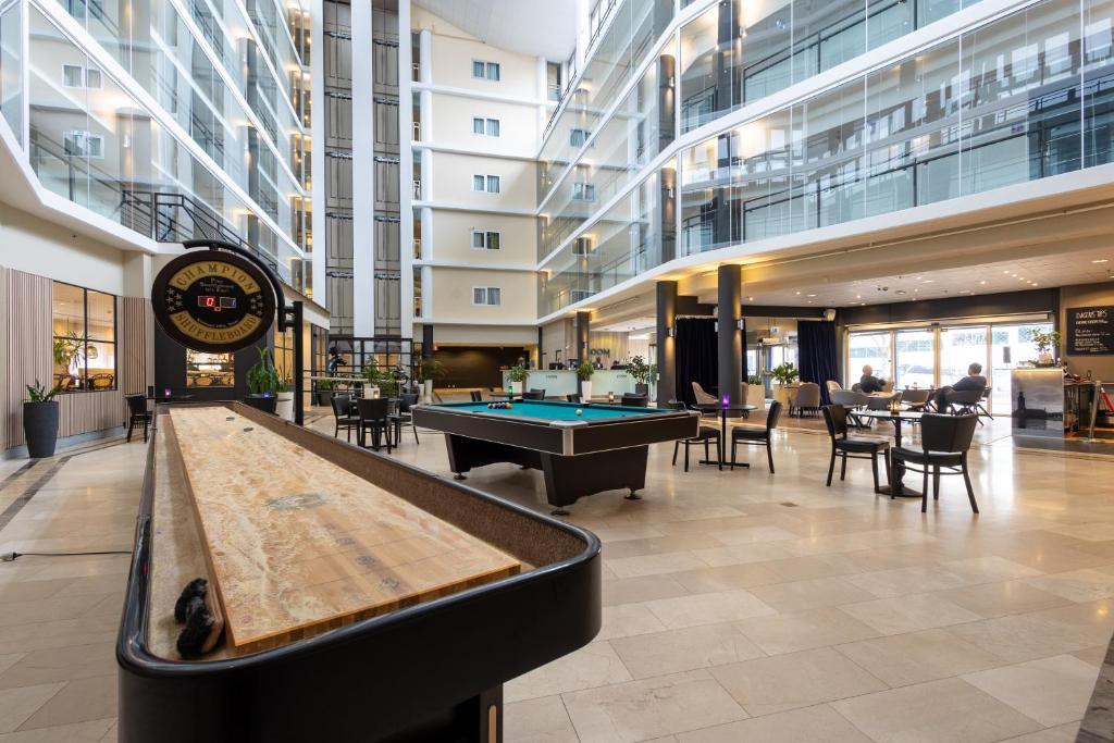 a lobby with a pool table in a building at HOOM Park & Hotel in Solna