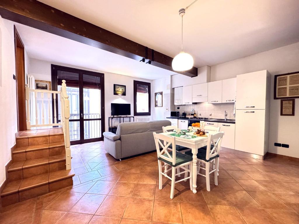 a kitchen and living room with a table and a couch at Realkasa Towers View in Bologna