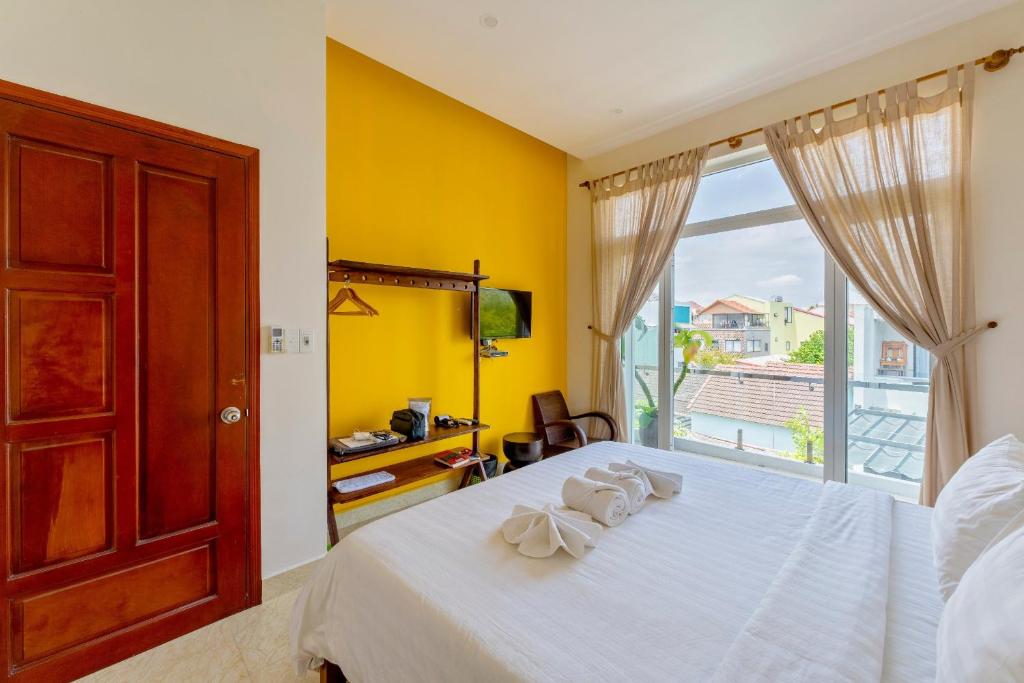 Postel nebo postele na pokoji v ubytování Green Town House Hoi An