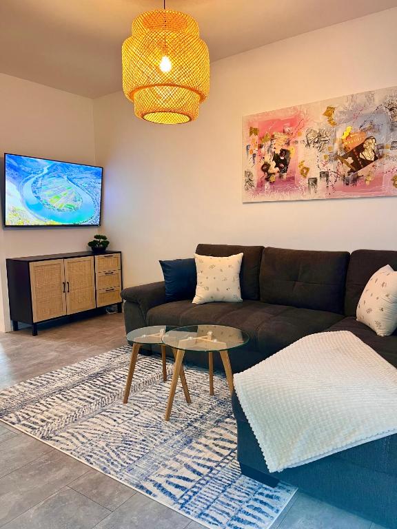 a living room with a couch and a table at Ferienwohnung Bloom in Bernkastel-Kues