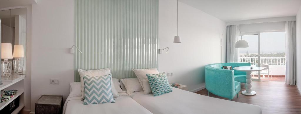 A bed or beds in a room at Gold By Marina - Adults only