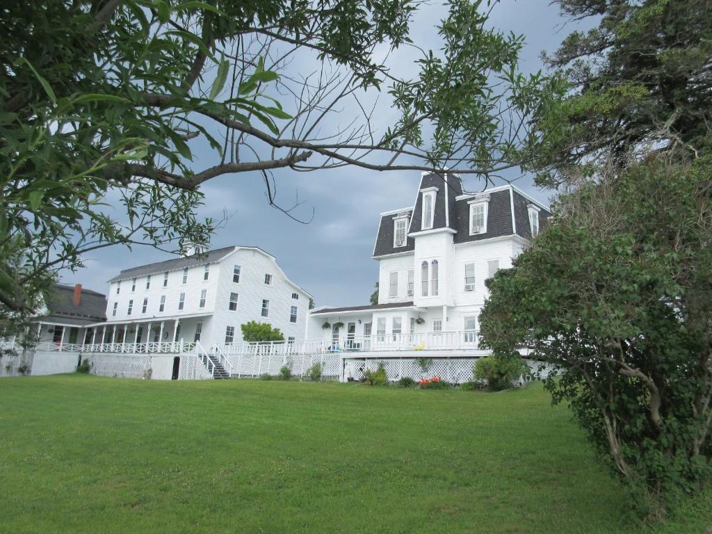 a large white building with a black roof at Marathon Hotel in North Head