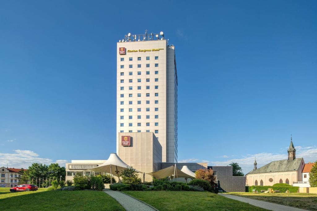 a tall white building with people on top of it at Clarion Congress Hotel České Budějovice in České Budějovice