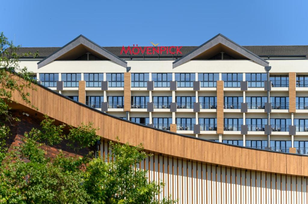 a building with a sign on top of it at Movenpick Resort and Spa Fruske Terme in Vrdnik