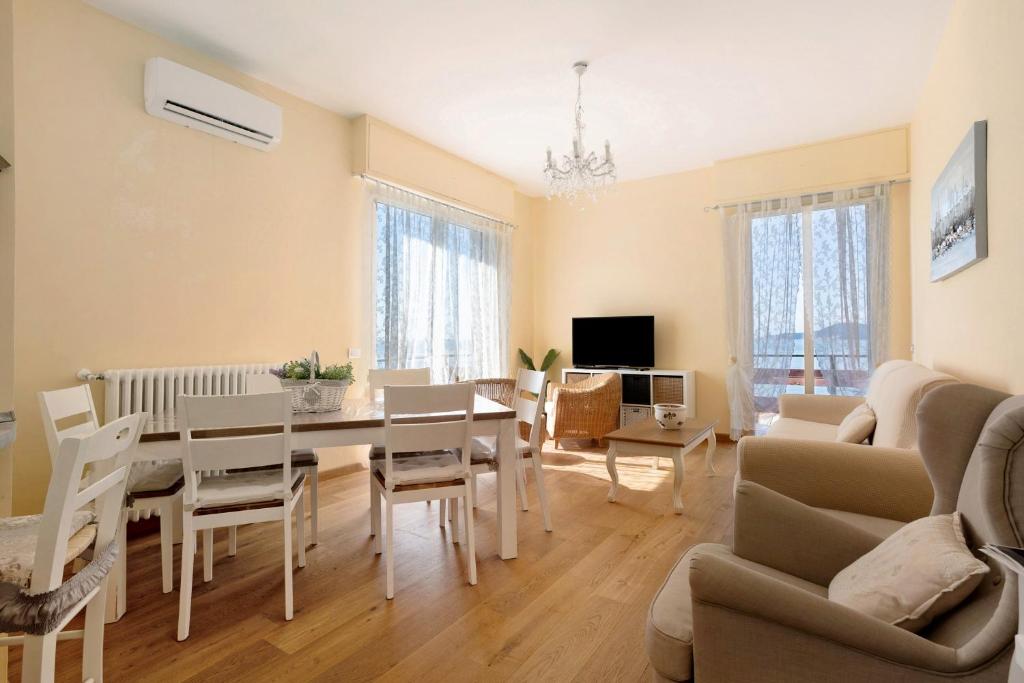 a dining room and living room with a table and chairs at Amazing view in Tellaro