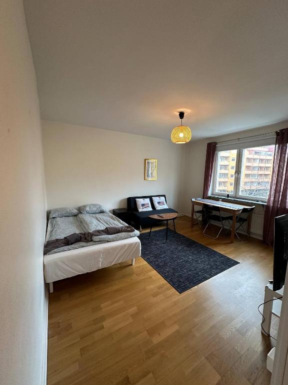 a bedroom with a bed and a desk in it at Beautiful And Comfortable Apartment in Gothenburg