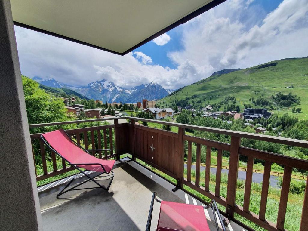 a balcony with a chair and a view of mountains at Meije 15 - A2 - Appart vue degagee- 6 pers in Les Deux Alpes