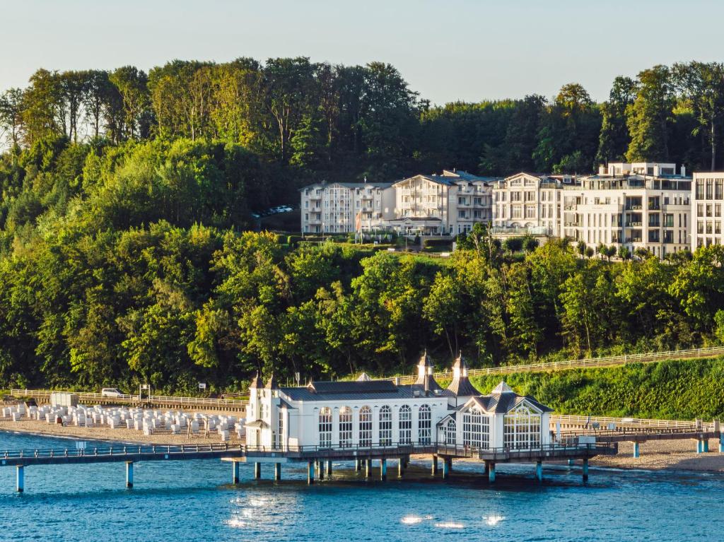 a large building on the water next to a pier at Hotel Bernstein in Ostseebad Sellin