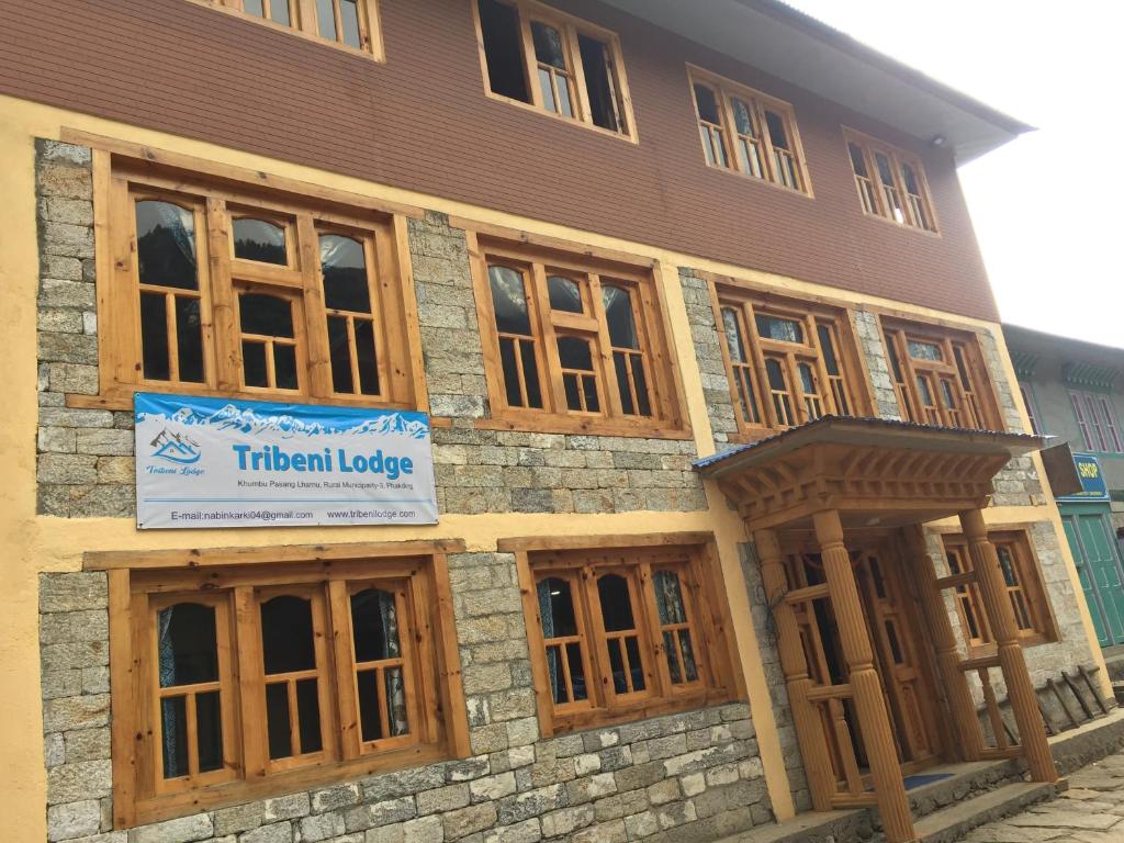 a building with a sign that reads thermal lodge at Tribeni Lodge Restaurant And Bar in Phakding