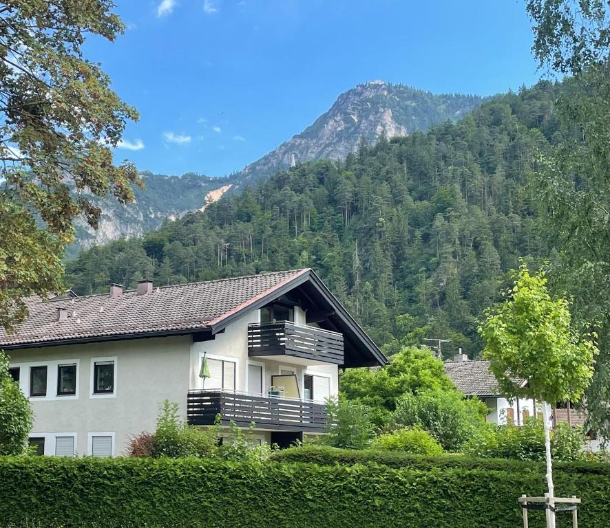 a house with a balcony in front of a mountain at Ferienwohnung Singer in Bad Reichenhall
