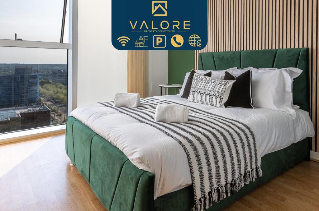 a bedroom with a large bed with a green headboard at Stunning 1-bed, Central MK, Free Parking, Smart TV By Valore Property Services in Milton Keynes