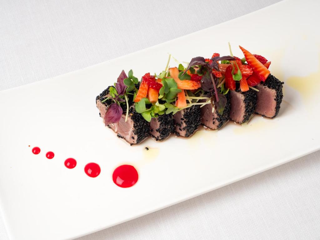 a white plate with a dish of food on it at Albatros Beach Hotel in Letojanni