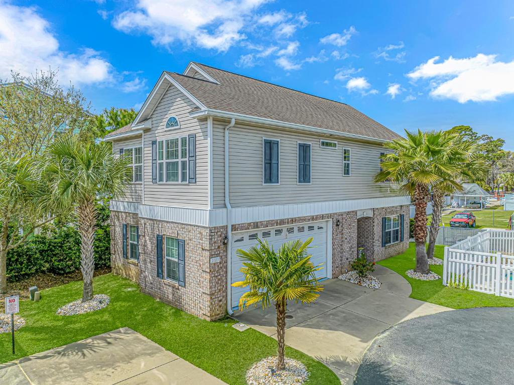 a house with palm trees in front of it at Spacious 4 Bedroom House-2 Blocks From the Ocean-2185 Sanibel Court! in Myrtle Beach