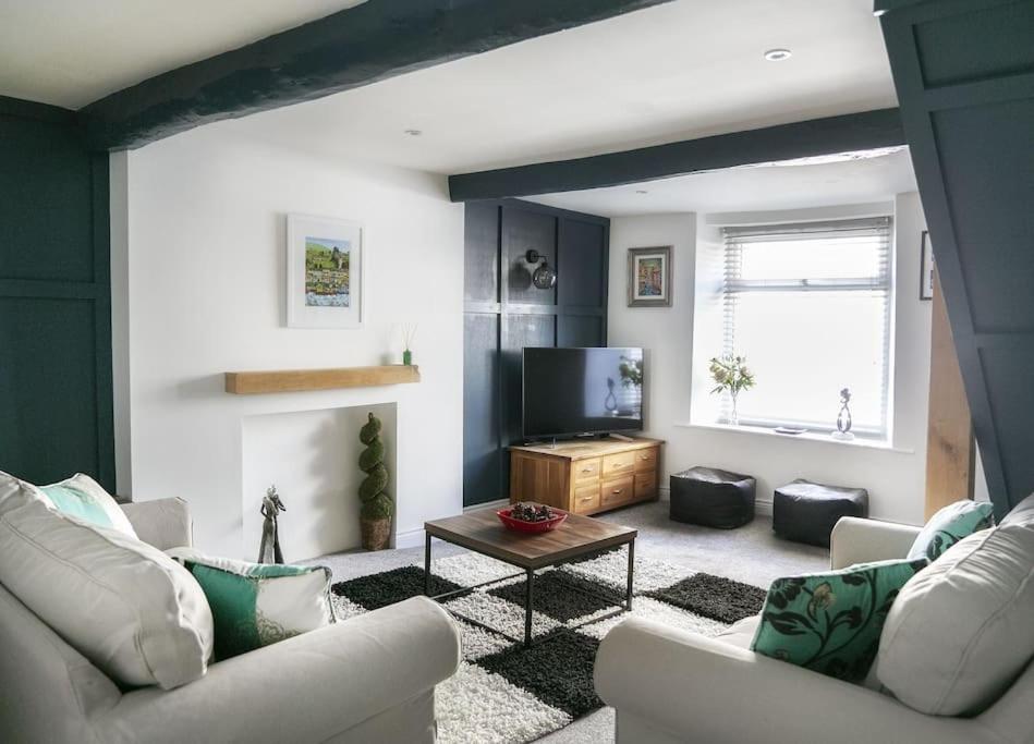 a living room with two couches and a tv at White Cottage deluxe 2 bedroom apartment in Grassington