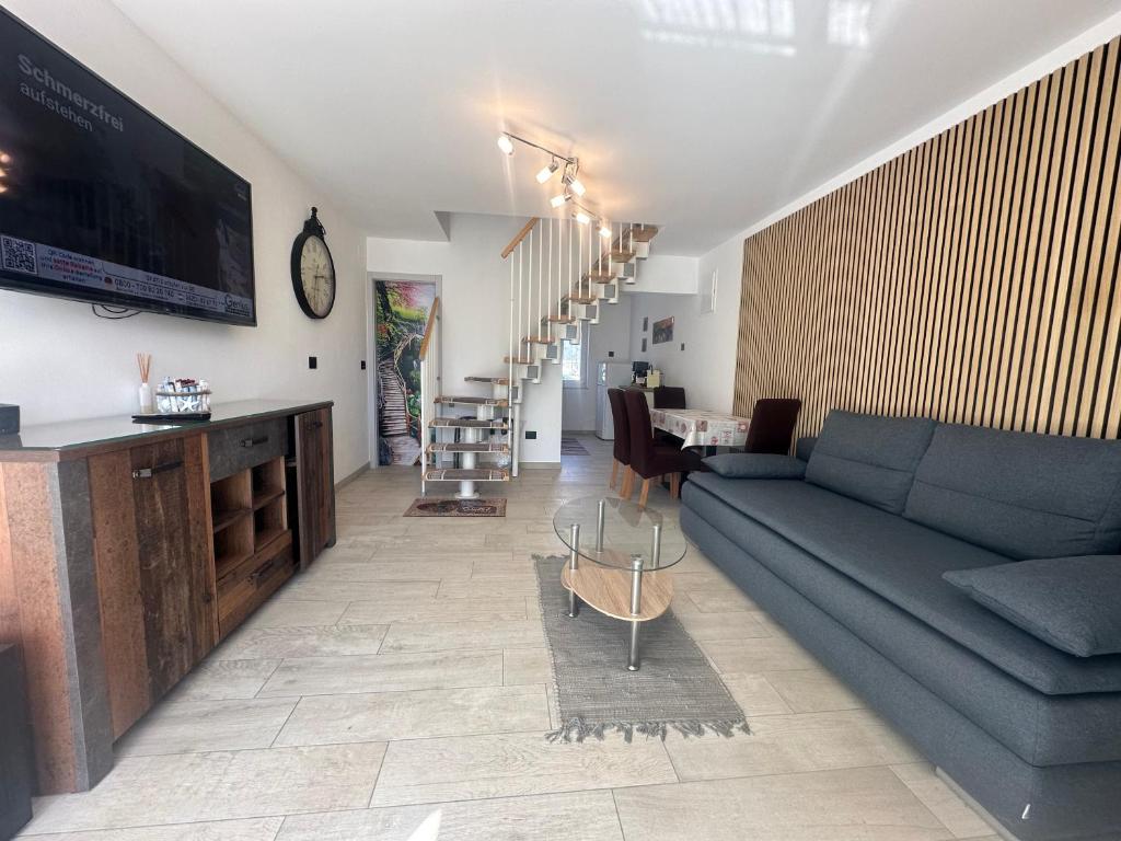 a living room with a blue couch and a tv at Villa Anthony in Rovinj