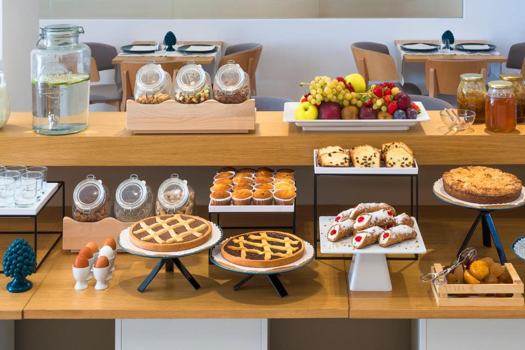 a table with many different types of desserts and pastries at Albatros Beach Hotel in Letojanni