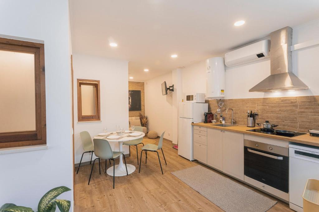 a kitchen and dining room with a table and chairs at Best Houses 77 - Best Village I in Peniche
