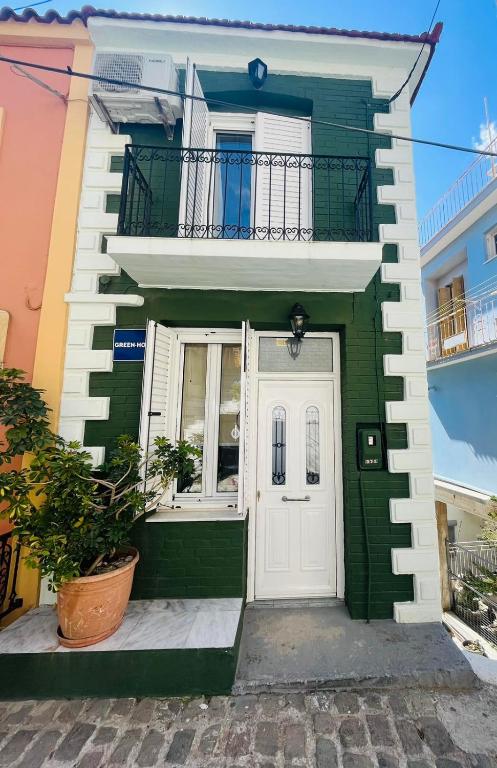 a green and white house with a white door at Green House - Central Stay in Plomari in Plomari