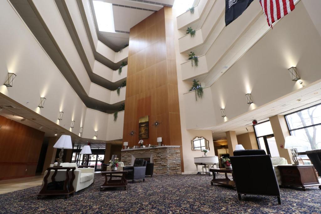 an empty lobby with an american flag hanging from the ceiling at Hotel Mead Resorts & Conventions Center in Wisconsin Rapids