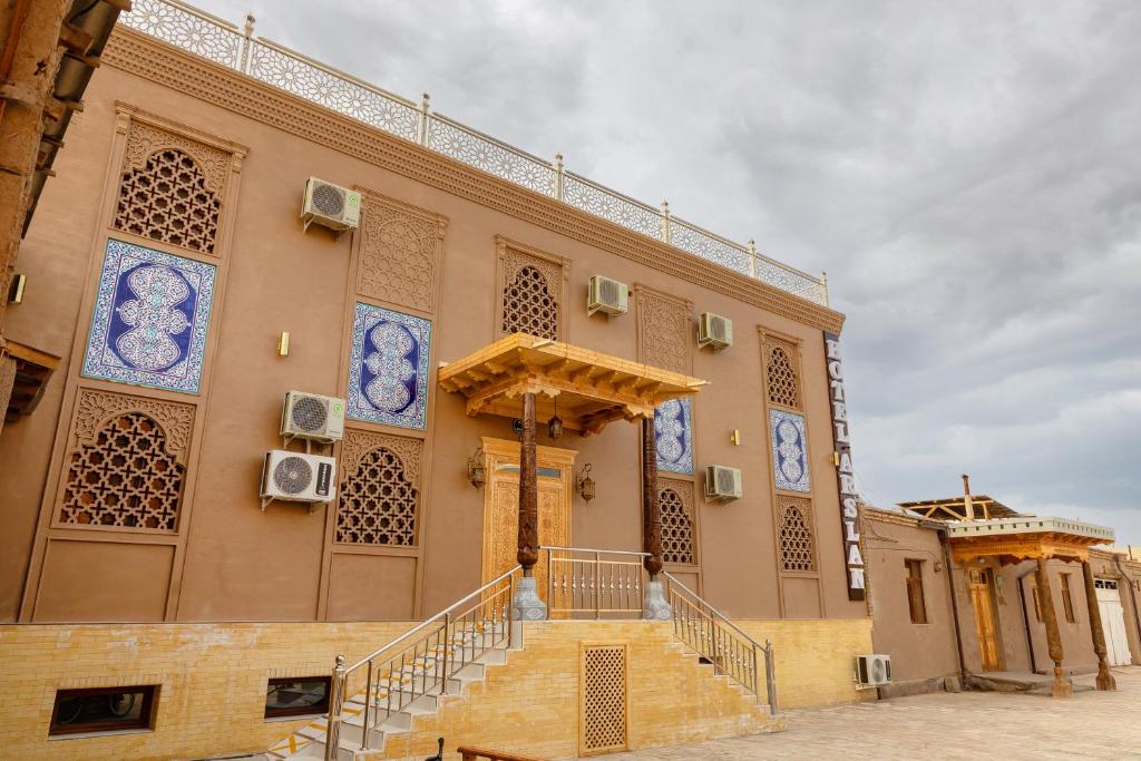 a building with a staircase in front of it at Arslan Boutique Hotel in Khiva