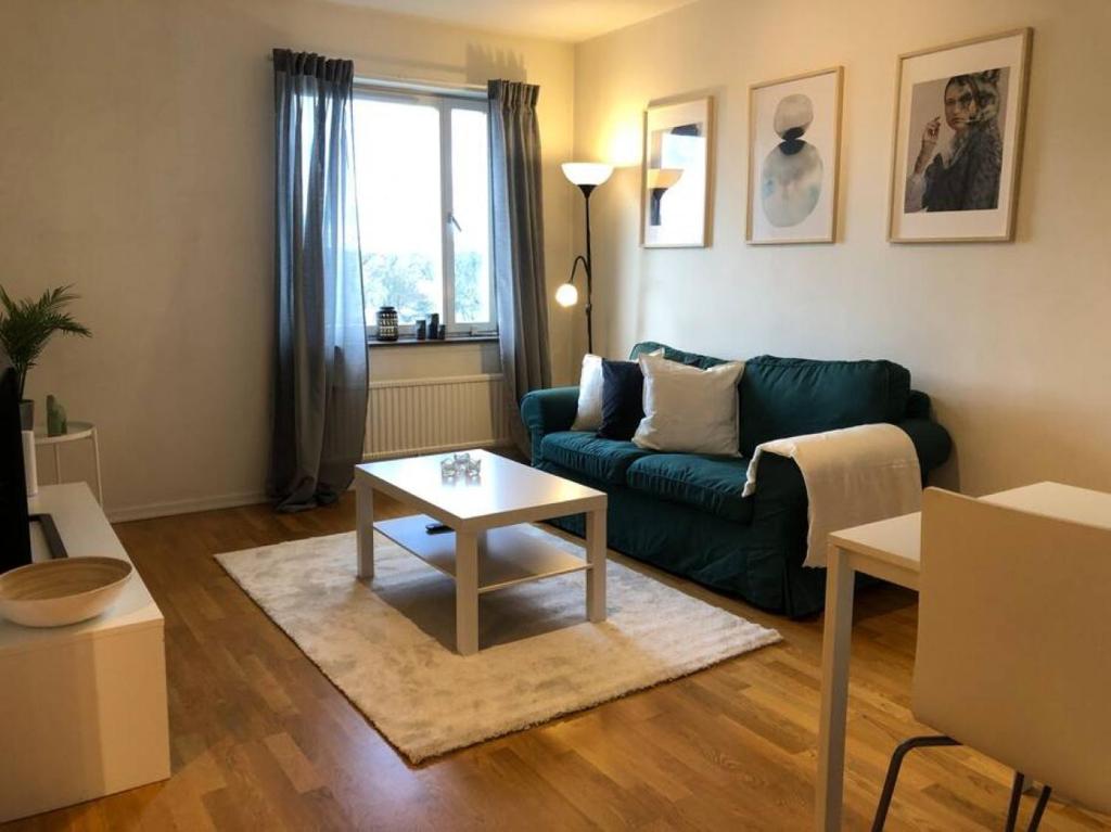 a living room with a couch and a coffee table at Great 1 bedroom apartment in Lidingö in Kottla