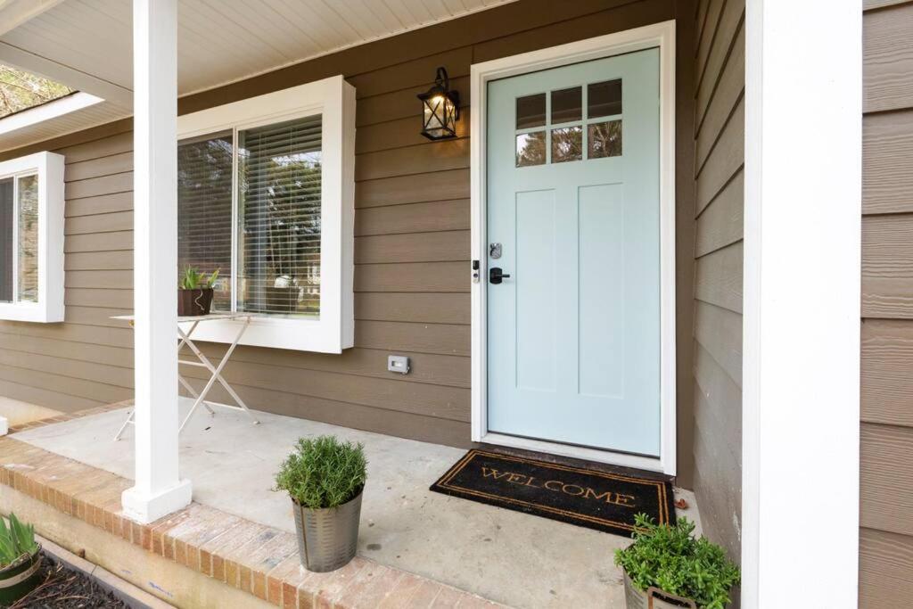 a white door on a house with a porch at Renovated Raleigh Bungalow in Raleigh