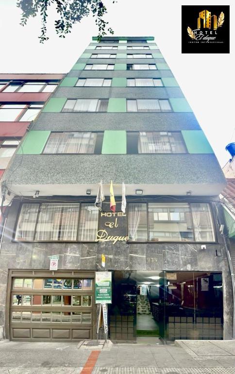 a tall building with a sign in front of it at Hotel el Duque Internacional, Bogotá in Bogotá
