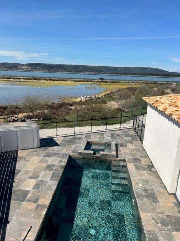 - une piscine sur une terrasse avec vue sur l'eau dans l'établissement Luxury between sea and pond evenings prohibited, à Frontignan