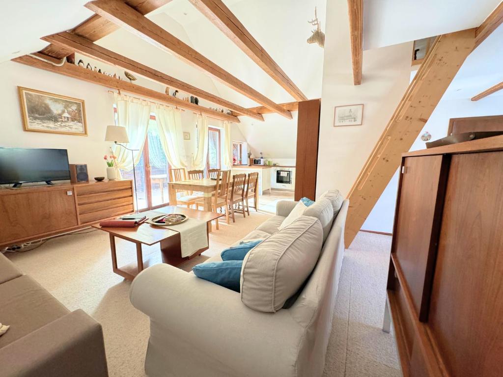 een woonkamer met een bank en een tafel bij Traditional house near Lake Bled & the Alps in Kropa