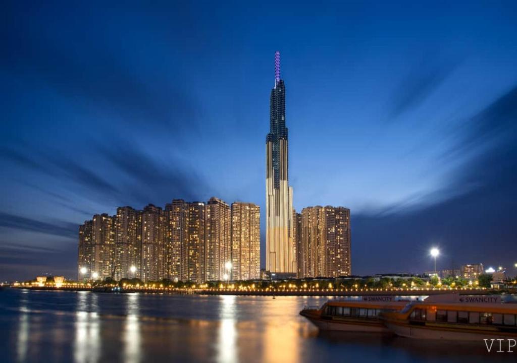 a tall skyscraper with a city at night at Landmark 81 Infinity Pool - VIP Apartment in Ho Chi Minh City