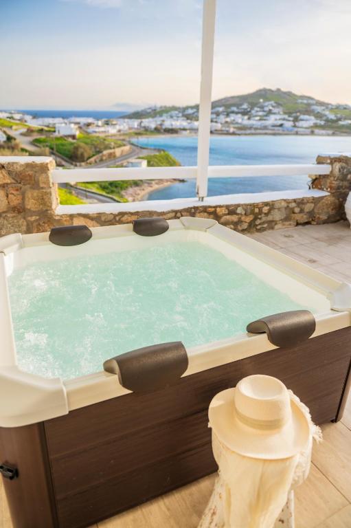 a hot tub with a view of the ocean at sunlight ornos suites, private hot tub in Mikonos